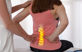 Woman suffering from low back pain during medical exam.