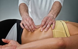 Osteopath working with patient