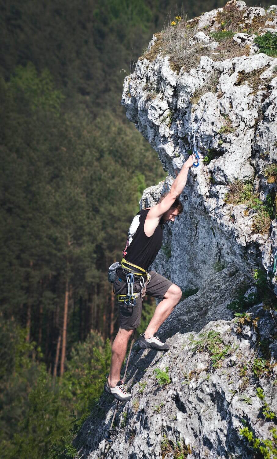 active man climbing on rocks