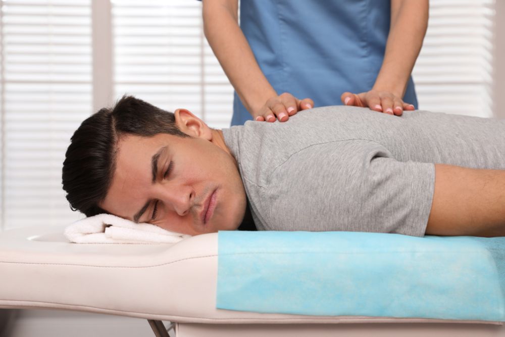 Orthopedist Massaging Man's Back in Clinic, Closeup.