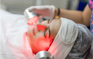 woman receives red light therapy to face