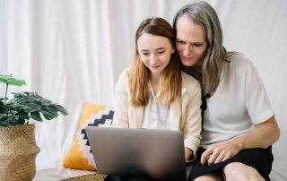 An Image of a Couple Staring at a Laptop