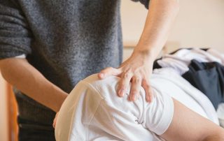 physio therapist working on a client's shoulder.