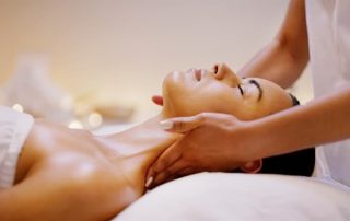Woman receiving a relaxing neck and shoulder massage during a professional spa therapy session