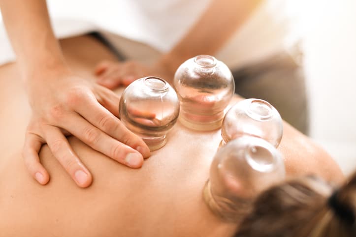 Cupping Therapy Treatment for Muscle Recovery and Pain Relief Woman with neck pain standing outside of her vehicle after a car accident
