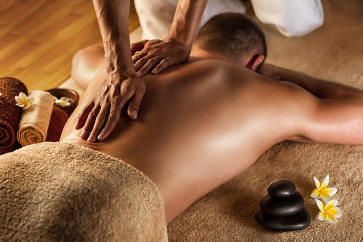 Therapeutic Back Massage in Relaxing Spa Environment Chiropractor performing back and shoulder adjustment on a patient in a clinic setting